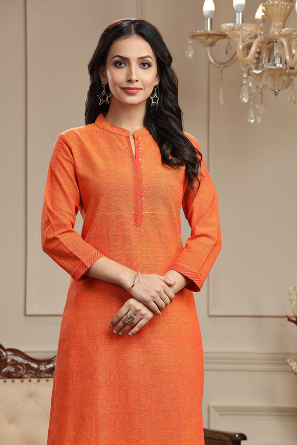 A graceful woman wearing a handwoven plain long kurta in a beautiful hue, adorned with intricate thread work on the neckline, cuffs, and hem. The kurta drapes elegantly, reflecting the timeless charm of traditional craftsmanship and modern style.