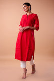 A graceful woman wearing a handwoven plain long kurta in a beautiful hue, adorned with intricate thread work on the neckline, cuffs, and hem. The kurta drapes elegantly, reflecting the timeless charm of traditional craftsmanship and modern style.